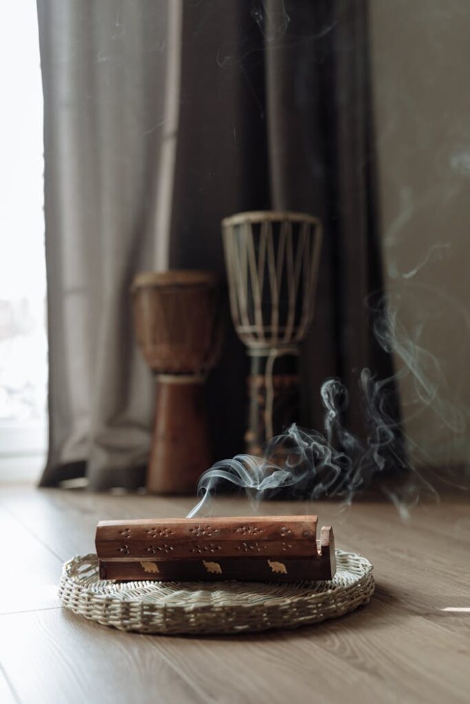 Aromatic incense burning on a woven mat with djembe drums, creating a soothing atmosphere.